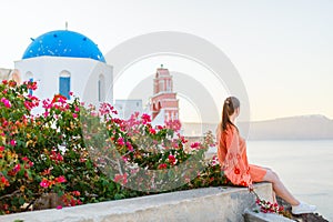 Beautiful girl in Oia village on Santorini island