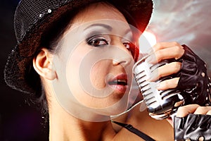 Beautiful girl with old retro microphone
