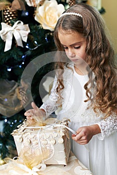 Beautiful girl opens gift for the new year