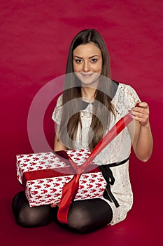 Beautiful girl opens her christmas gift