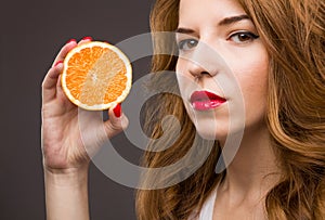 Beautiful girl with orange fruit