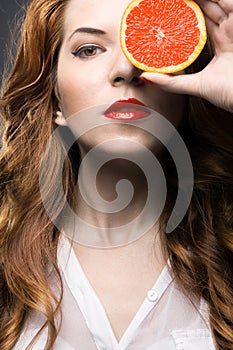 Beautiful girl with orange fruit
