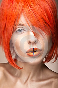 Beautiful girl in an orange wig cosplay style with bright creative lips. Art beauty image.