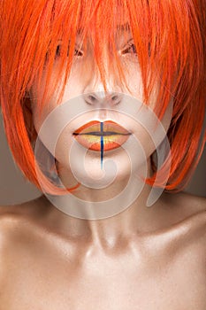 Beautiful girl in an orange wig cosplay style with bright creative lips. Art beauty image.