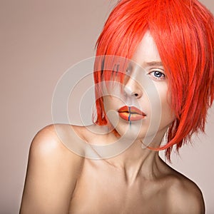 Beautiful girl in an orange wig cosplay style with bright creative lips. Art beauty image.