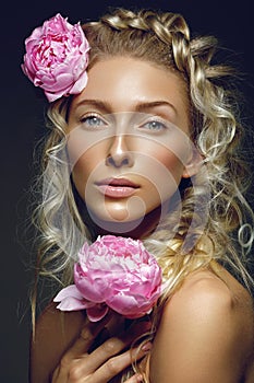 Beautiful girl with peony flower