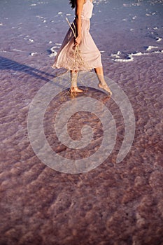 Beautiful girl on a pink lake.