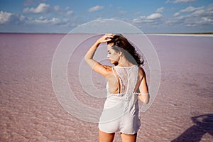 Beautiful girl on a pink lake.