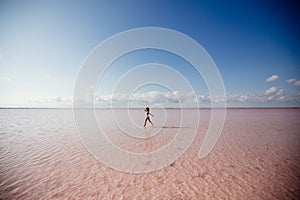 Beautiful girl on a pink lake.