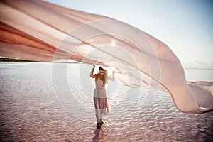 Beautiful girl on a pink lake.