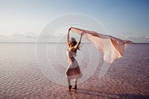 Beautiful girl on a pink lake.