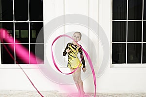 Beautiful girl with Pink Rhythmic gymnastics ribbon