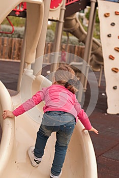 The beautiful girl play on the playground