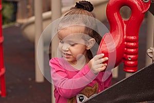 The beautiful girl play on the playground