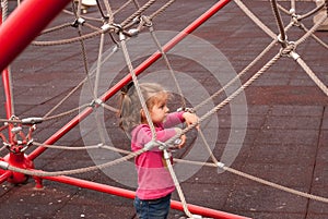 The beautiful girl play on the playground