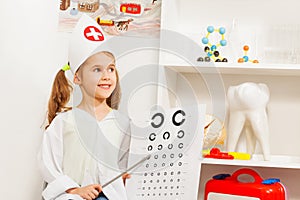 Beautiful girl playing oculist at medical office