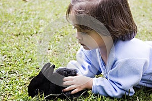 Beautiful girl playing with a rabbit