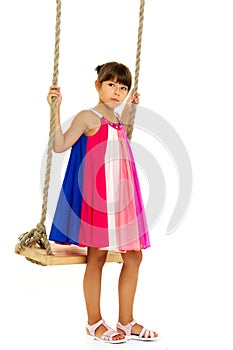 Beautiful girl playing on swing