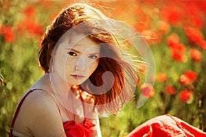 Beautiful girl in poppy field