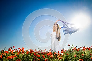 Beautiful girl in the poppy field