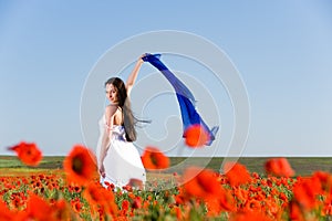 Beautiful girl in the poppy field
