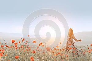 Beautiful girl in a poppy field at sunset.