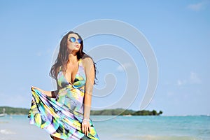 Beautiful girl posing on the beach in hot sun, outdoor portrait