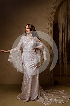 Beautiful girl posing in a boho style wedding dress