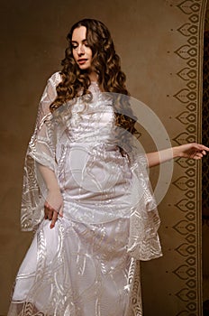 Beautiful girl posing in a boho style wedding dress