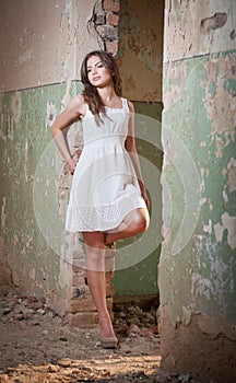 Beautiful girl posing fashion near an old wall