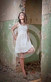 Beautiful girl posing fashion near an old wall