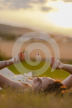 Beautiful girl posing in a field at sunset