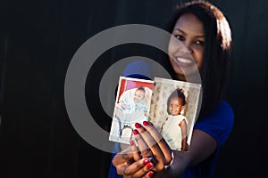 Beautiful girl posing holding her baby pictures