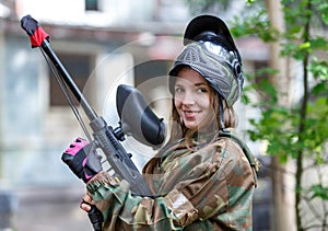 Beautiful girl posing in paintball ammunition outdoors