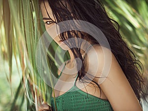 Beautiful girl posing in tropical forest. Close-up perfect portrait