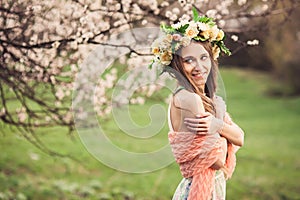 Beautiful girl posing under cherry tree