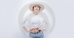Beautiful girl posing on a white background in a beautiful yellow hat. Tourism concept