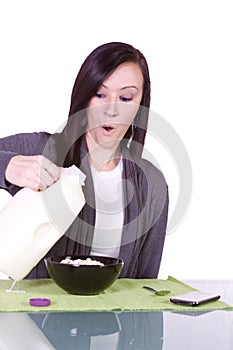 Beautiful Girl Pouring Milk to her Cereal