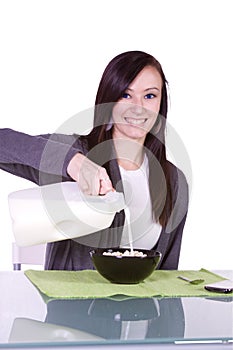 Beautiful Girl Pouring Milk to her Cereal