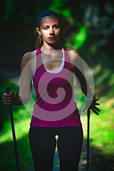 A beautiful girl practices Nordic walking
