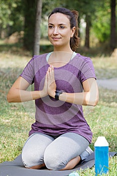 beautiful girl practices yoga in morning forest