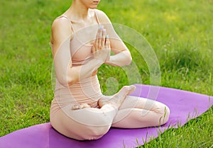 Beautiful girl practicing yoga in the nature. Calm, meditation
