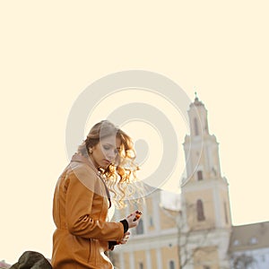 Beautiful girl praying on the background of the church