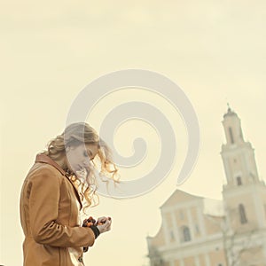 Beautiful girl praying on the background of the church