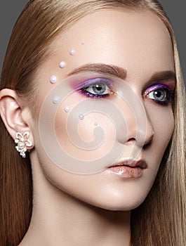 Beautiful Girl with Professional Creative Makeup. Celebrate Eye Makeup, Perfect Eyebrows, Glow Skin. Bright Fashion Look