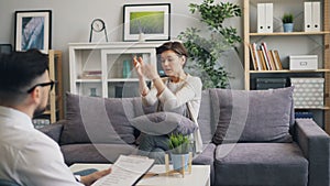 Beautiful girl and psychologist talking in office discussing troubles in life