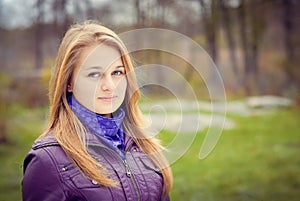 Beautiful girl in purple jacket having a stroll in