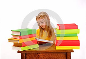 Beautiful girl reading a book surrounded by books