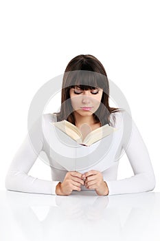 Beautiful girl reading a book on white