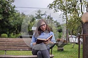 Beautiful girl reading books in the garden